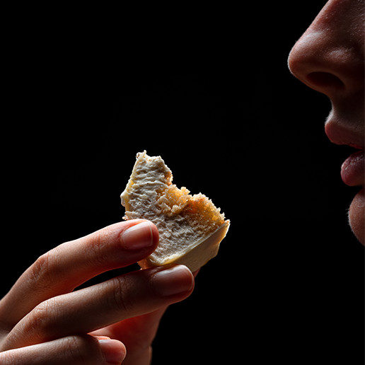 Woman savoring a bite at Dans le Noir ?